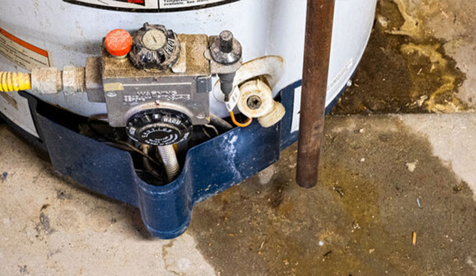 a water heater in a drip pan full of water