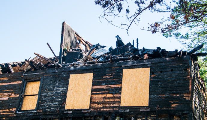 Professional board-up service for fire-damaged house