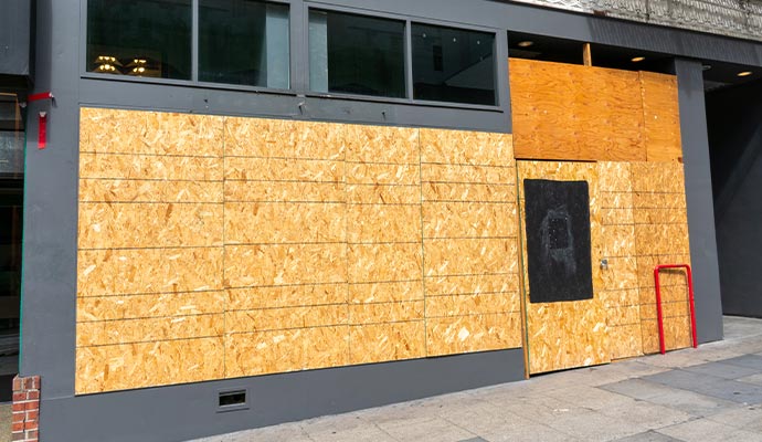 Boarded-up building exterior Exterior of a building with boarded-up entrance