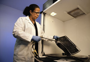 Technician cleaning a keyboard with water