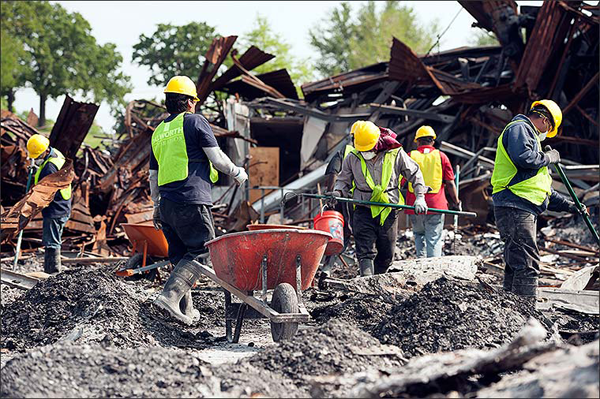 Technician cleaning up fire damaged debris