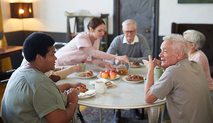 Diverse Group Senior People Enjoying Breakfast Round Table Modern Nursing Home