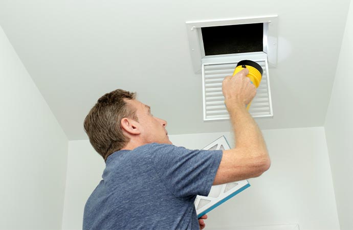 worker inspecting duct