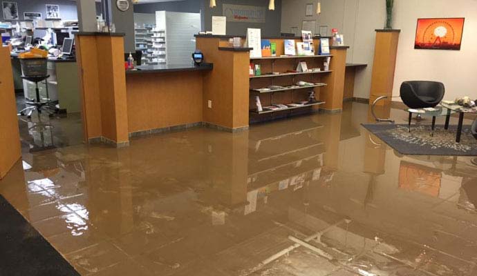Flooded office reception area with standing water