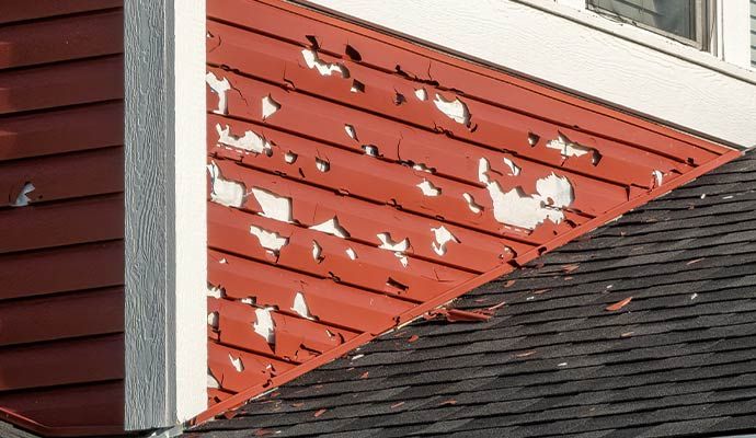 House with hail damaged red sidings