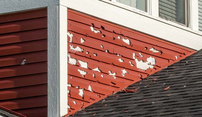 Hail damaged vinyl siding on residential house