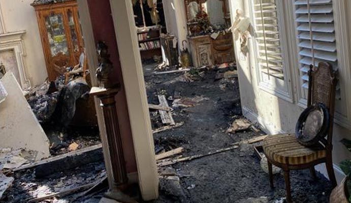 Interior view of a living room severely damaged by fire