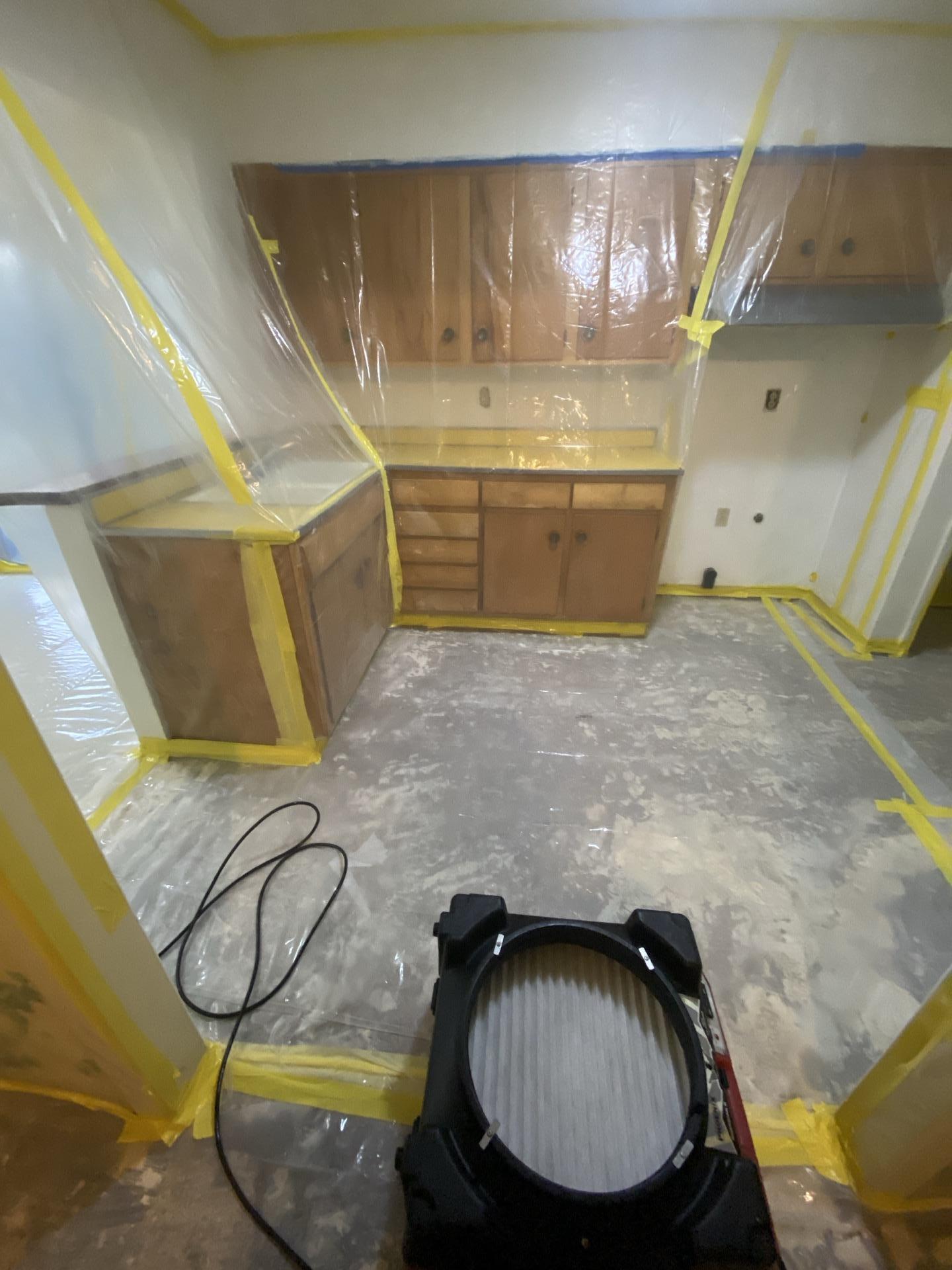 Kitchen area with professional containment and air filtration during sewage cleanup and biohazard mitigation. Structural drying and sanitizing and disinfecting ensure safe property restoration.