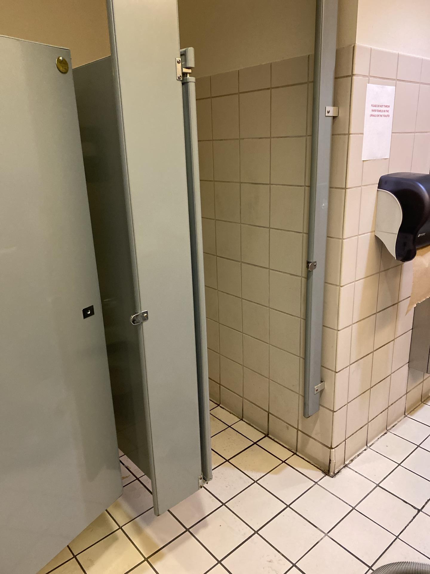 Initial view of sewage backup in a commercial restroom, requiring immediate contaminated water extraction and biohazard cleanup for health and safety compliance in property restoration.