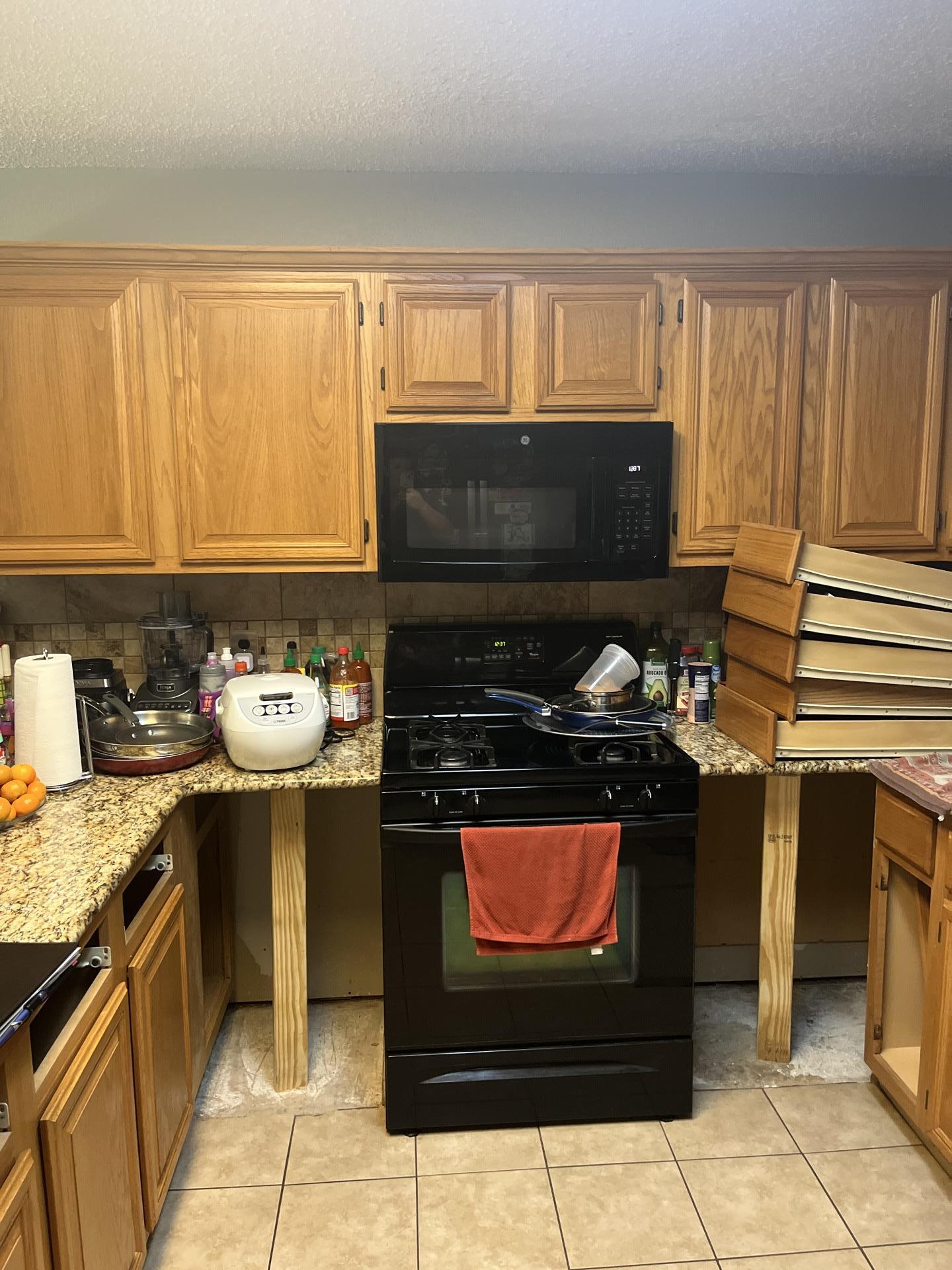 Temporary wood framing supporting a kitchen counter during structural water damage mitigation services.