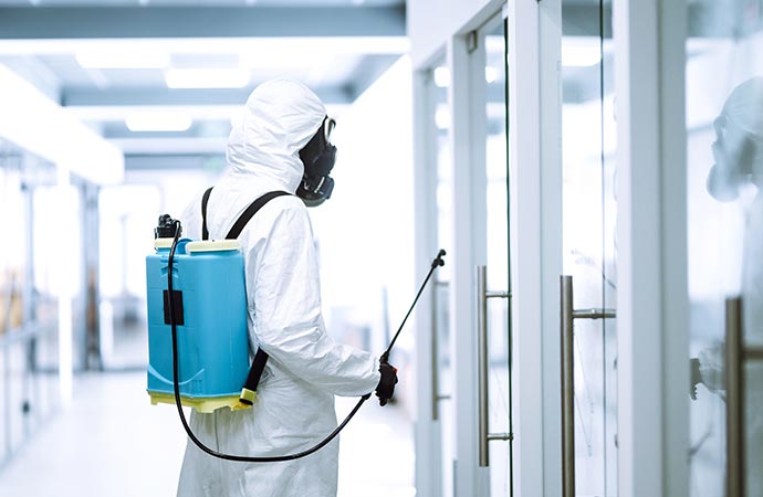 Professional worker disinfecting the room