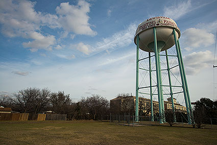 The Lewisville, TX water tower shows the town's pride with the Fighting Farmers logo.