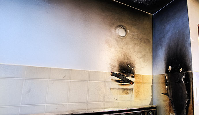 Wall and ceiling with significant fire and smoke damage