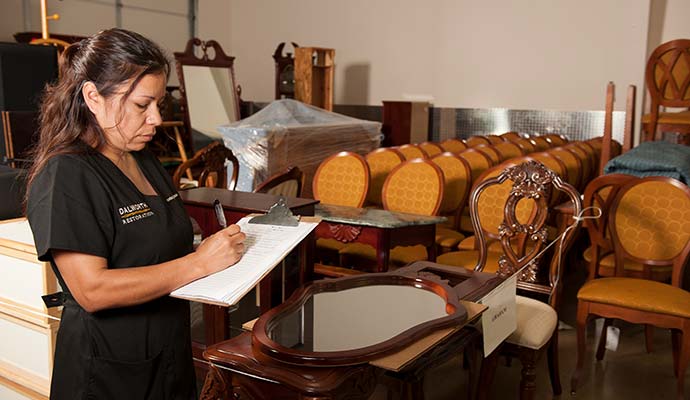 Specialist inspecting furniture for contents restoration