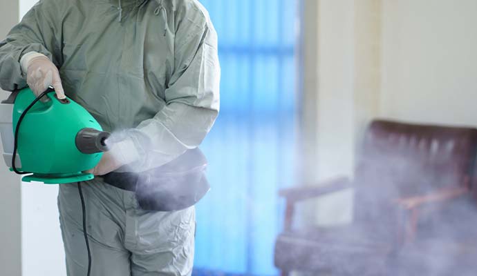 Technician using fogger machine for smoke odor removal