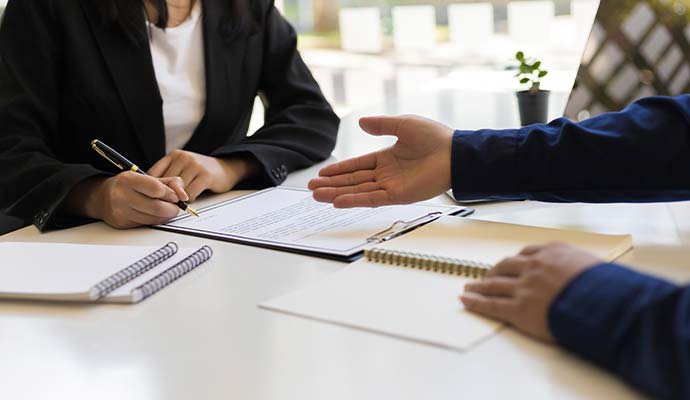Two people reviewing insurance claim documents