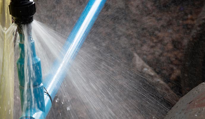 Burst main water pipe spraying water