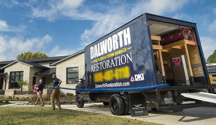 Dalworth Restoration service truck parked outside a residential home