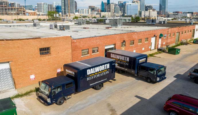Dalworth Restoration trucks parked outside building