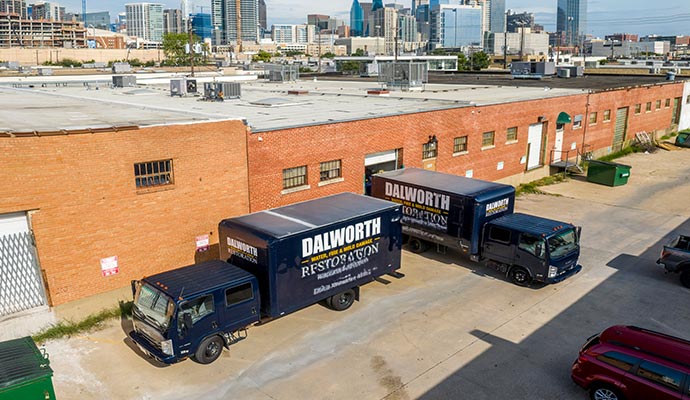 Dalworth Restoration service vehicles parked outside a commercial space