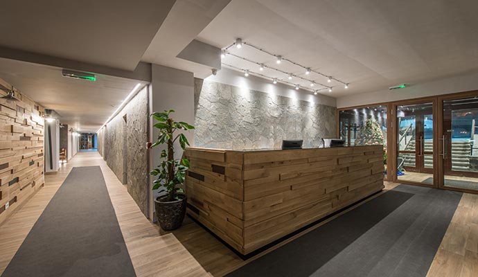 Modern hotel reception area with wooden front desk