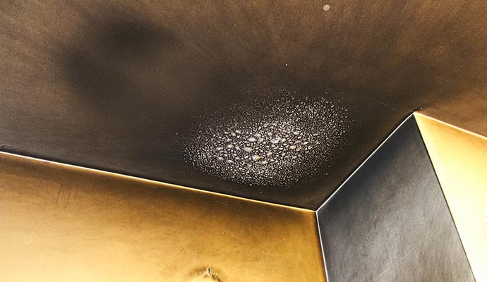 Ceiling with heavy smoke and soot damage after a fire