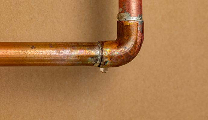 Water droplets falling from a leaking pipe