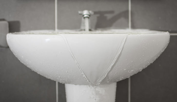 Water overflowing from a bathroom sink