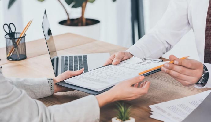 Client receiving documents from assistant for signing