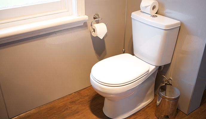 Clean toilet after sewage removal and cleanup services