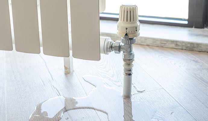 Water on the floor from leaking pipes